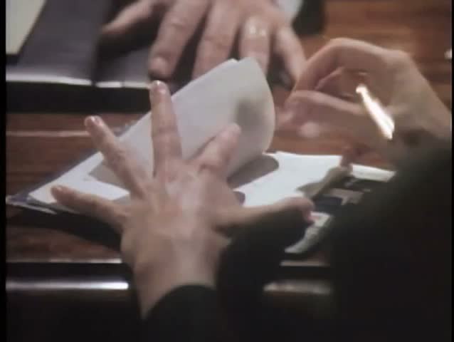 Hand tearing off check from check book