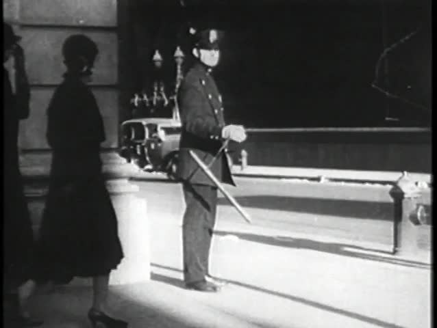 Policeman twirling night stick on New York City street, 1930s