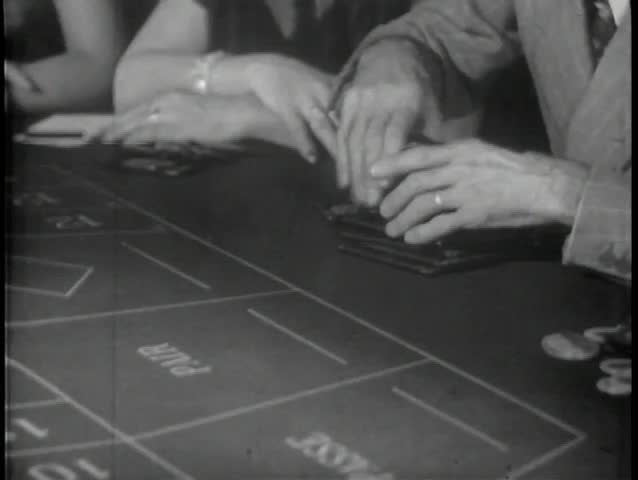 Close-up of hands playing roulette in casino
