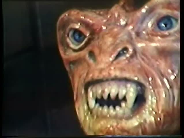 Close-up of alien spewing yellow liquid