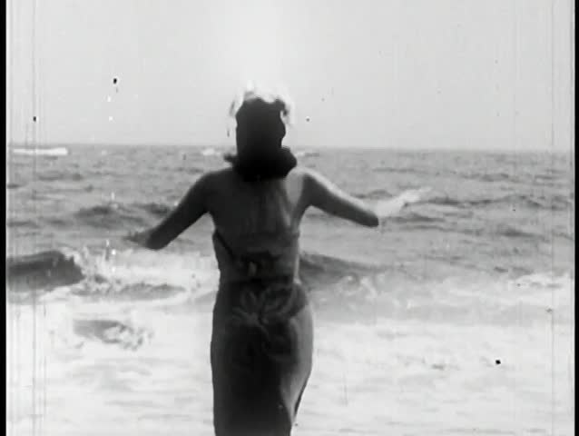 Rear view of woman walking into ocean