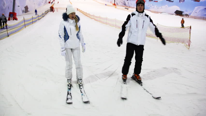 instructor shows girl some basic exercises to control balance on ski