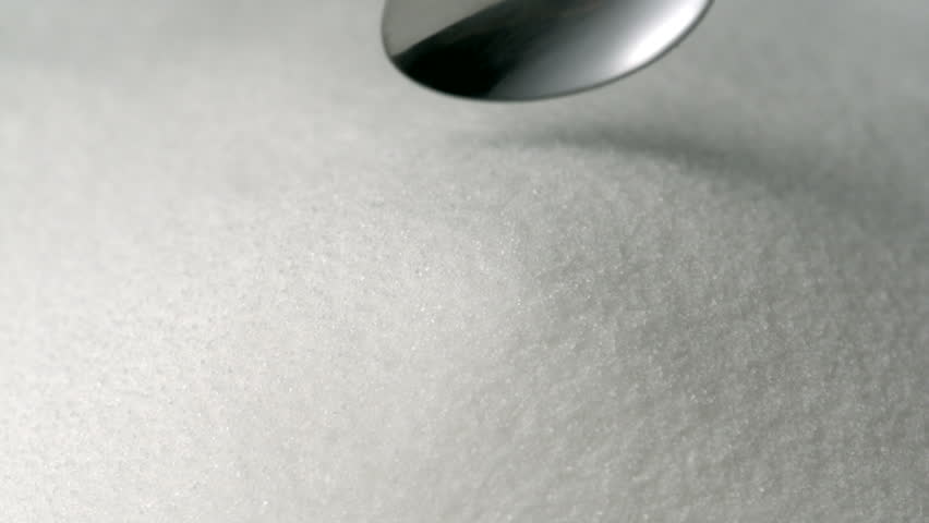 Silver spoon scoops up sugar