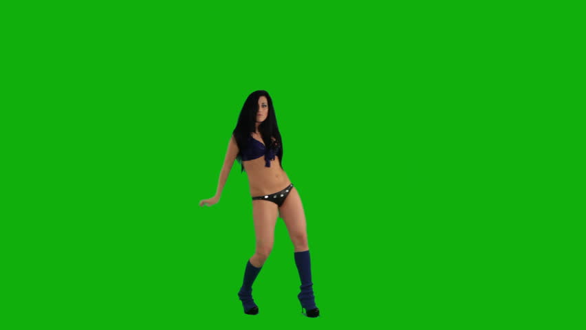 Beautiful young girl dancing against green screen 