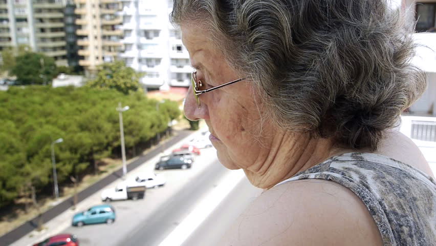 Old retired woman watching traffic from balcony - Retirement Home - Transportation - Full HD