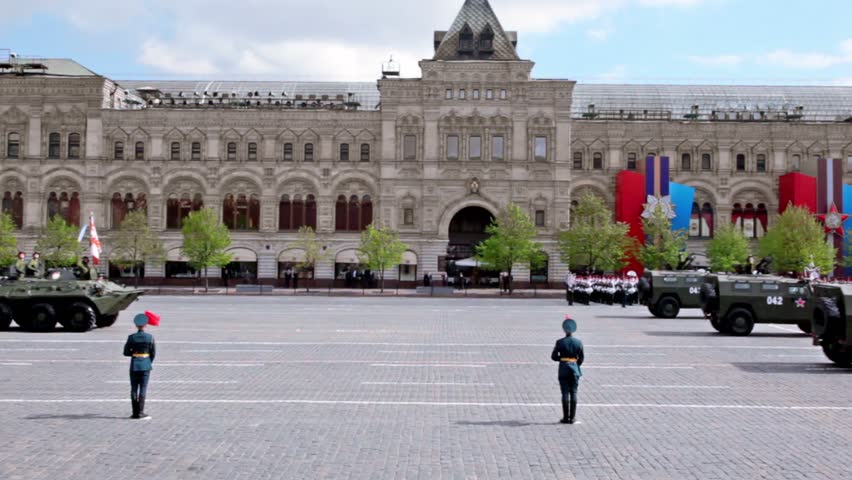 MOSCOW - MAY 9: Carriers with soldiers on it ride by Red square on Victory Parade at background of military orchestra near gum on May 9, 2011 in Moscow, Russia.