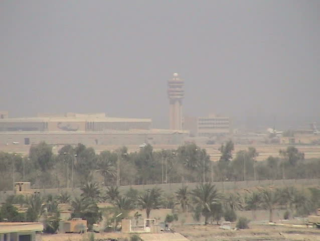 BAGHDAD, IRAQ - CIRCA 5/8/03: Shortly after being captured by U.S. Forces, blown-up airliner on runway and mortar hole in tarmac, C-130 taking off.