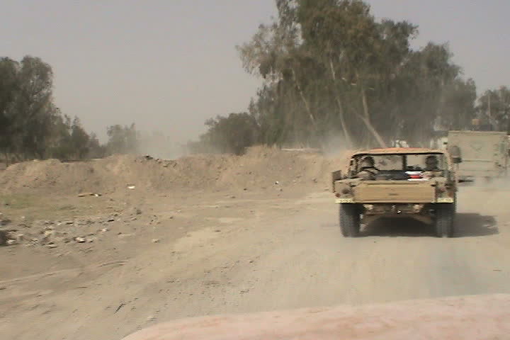 AL MOHAMMADIYA, IRAQ - CIRCA 5/16/03: Softskin Humvees patrolling dirt roads.