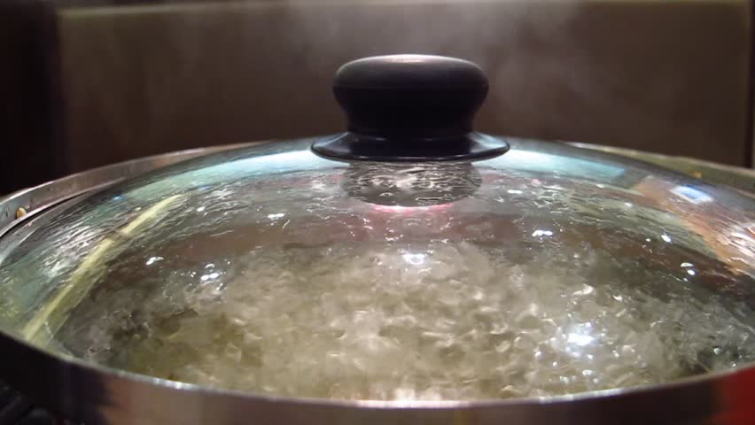 Boiling water, hot water in pot and steam. 