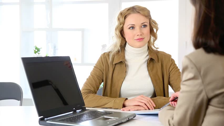 Young woman in agency signing contract