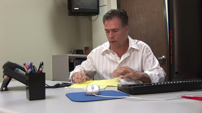 a man bored with his job and makes a paper airplane
