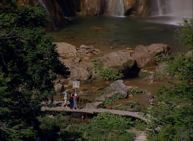 Tourist on a footpath walking and looking to the waterfalls and lakes in National park Plitvicka jezera circa July 2000 in Plitvice Lakes. 