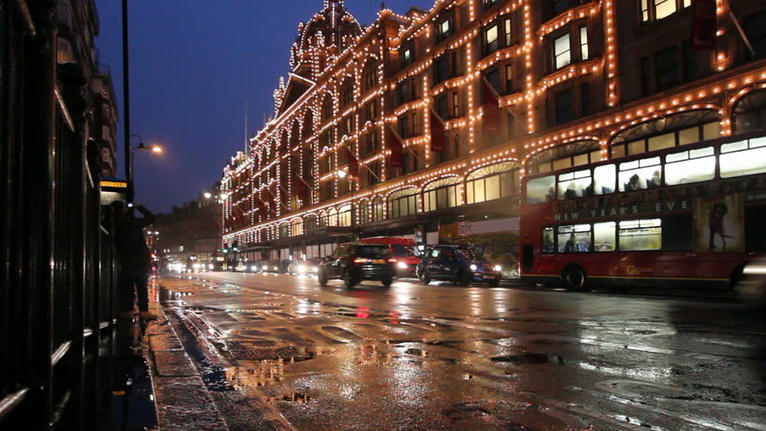 LONDON, UK - DECEMBER 28: Traffic drives past Harrods Department Store decorated for Christmas on December 28, 2011 in London, UK. Harrods is the most famous department store in London