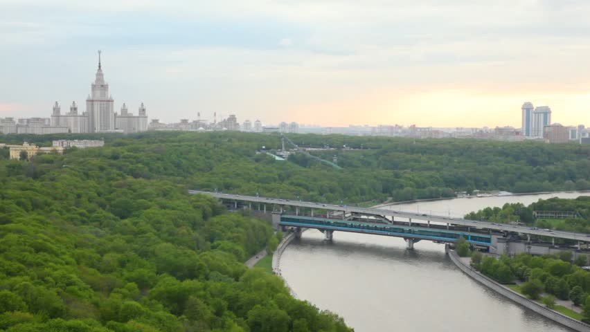 Luzhnetsky bridge stands against the Moscow State university and sunset
