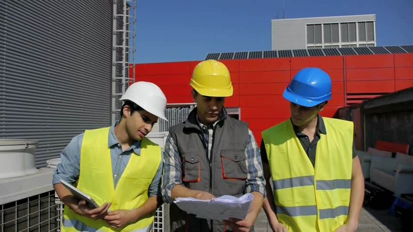 Construction foreman training young people on site