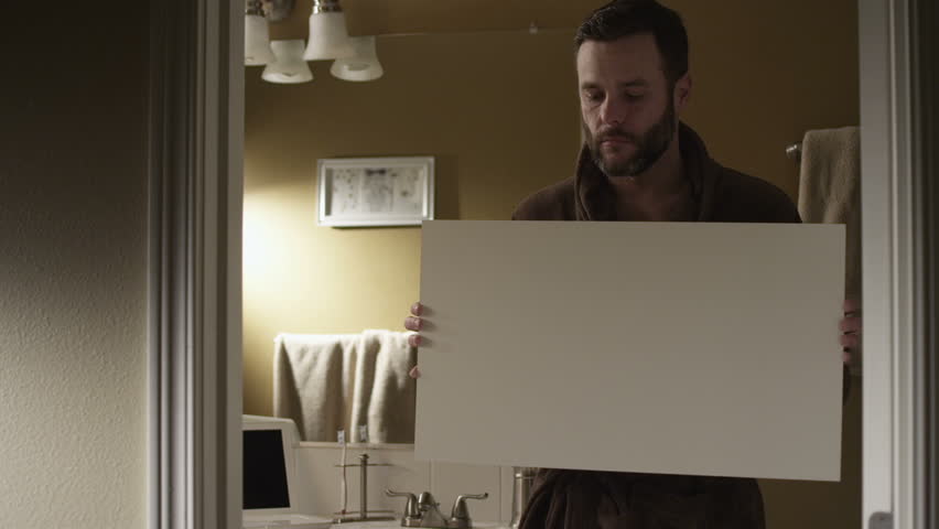 A couple  balancing home life and professional life. Authentic moments around the house are captured as the couple gets ready for the day, completes work on the computer.