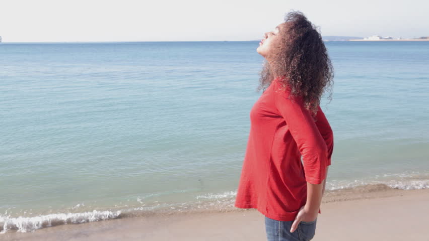Girl breathing fresh air by the sea.