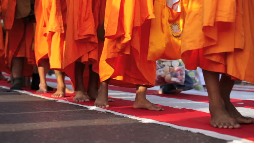 BANGKOK - MARCH 17: Monks are participating in a Mass Alms Giving of 12,600 monks in Saphan Khwai for the Makha Bucha celebrations on March 17, 2012 in Bangkok, Thailand.