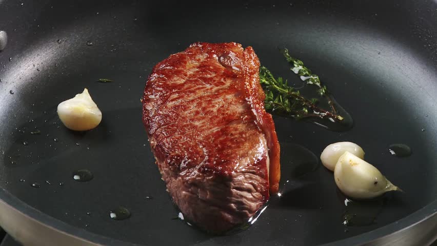 Frying beef sirloin in a frying pan
