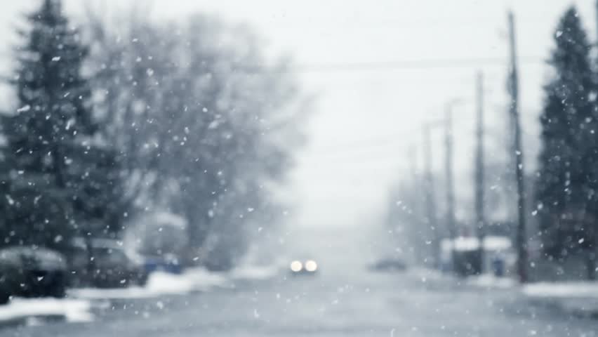 Defocused blizzard with a car coming