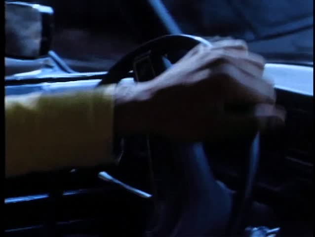 Close-up of person turning steering wheel in car