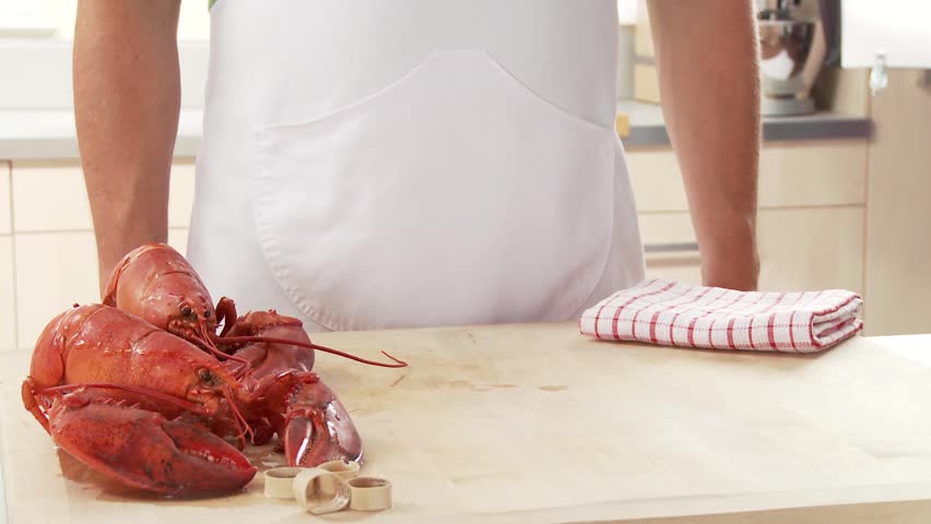 Cooked lobster being served with butter and lemon