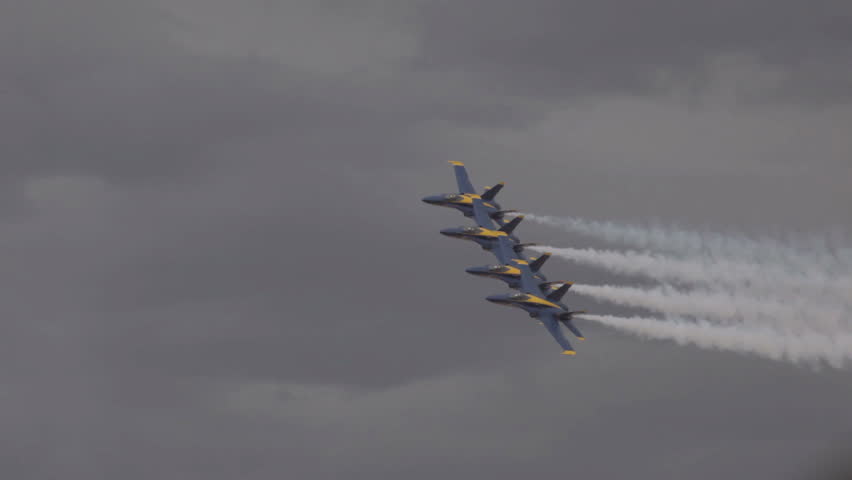 ST GEORGE, UTAH - MARCH 17: Navy Blue Angel demonstration fighter jets fly by in close formation on March 17, 2012 in St. George, Utah. Yellow and blue supersonic F18 Hornet aircraft in finger tip formation