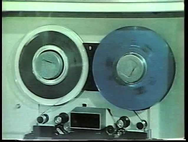 Woman transcribing recorded data in 1970s computer room