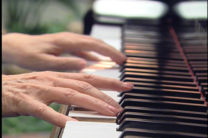 Older hands playing the piano