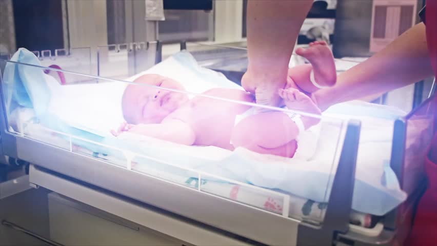A newborn baby at the hospital born just minutes before being cleaned by the nursing staff.