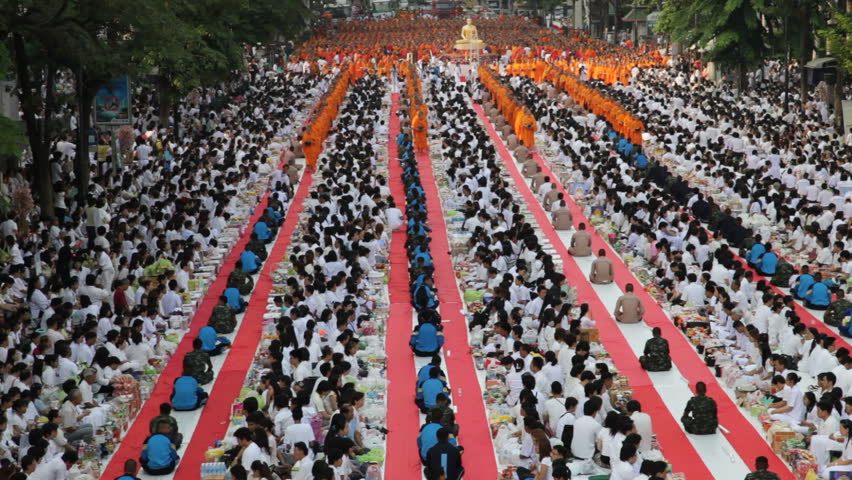 BANGKOK - MARCH 25: Monks are participating in a Mass Alms Giving of 12,600 monks in Central World for the Makha Bucha celebrations on March 25, 2012 in Bangkok, Thailand.