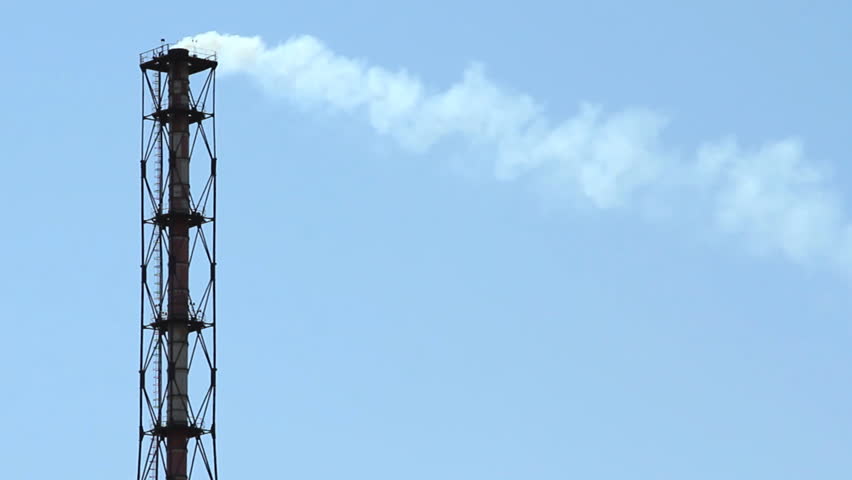 tube with smoke over blue sky