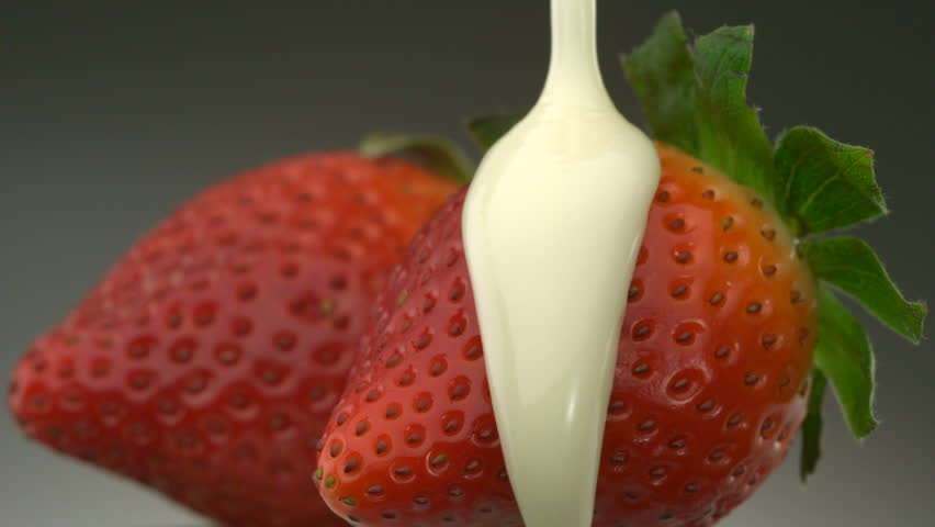 Close-up white chocolate over strawberries