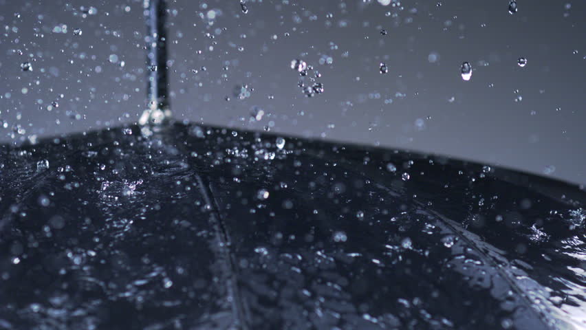 Slo-mo rain hitting umbrella