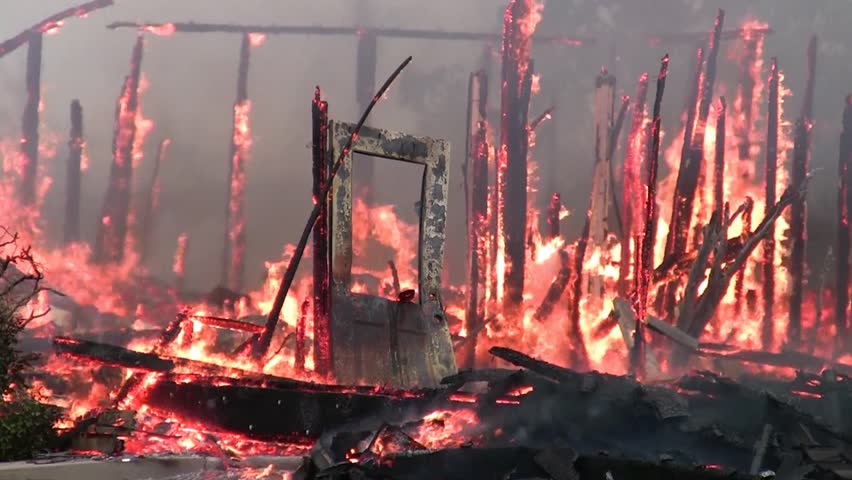 Though badly warped, the front door of this house stands in defiance of the fire that has consumed it.  Fires are a leading cause of accidental death. Thankfully no one was injured in this blaze.
