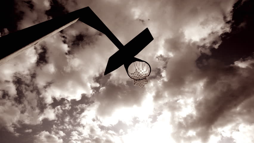 Basketball player dunking basketball and scores in basket