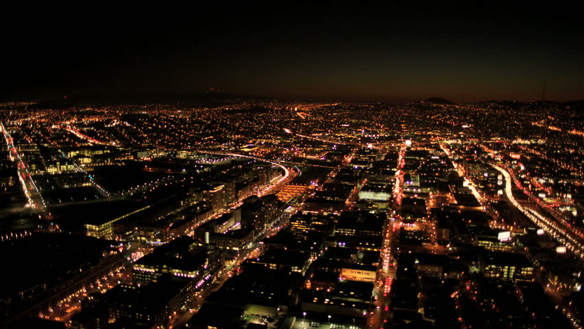 Aerial night illuminated cityscape view of rolling city streets and districts, San Francisco, North America, USA