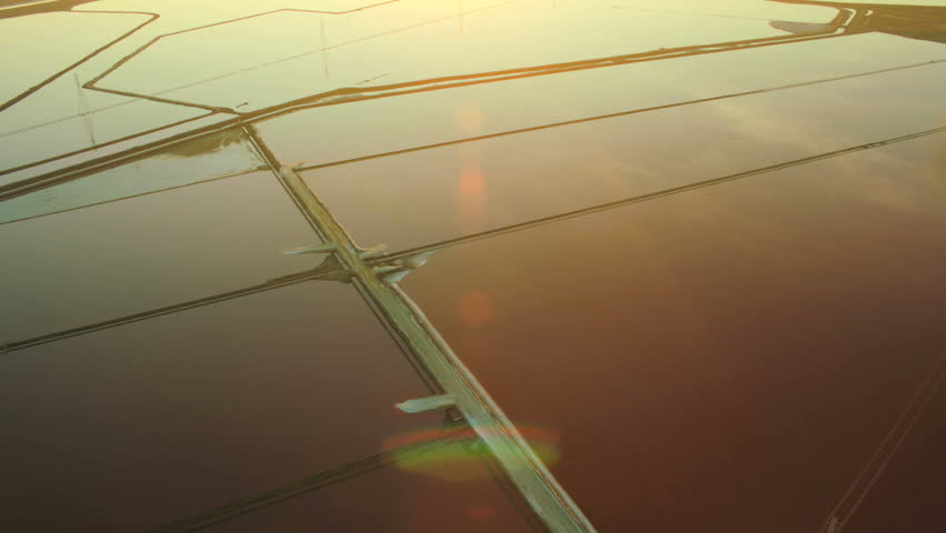 Aerial view of salt pans designed to produce salt by solar energy by evaporation for manufacturing