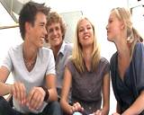 Young students talking together and giving a thumbs up to the viewer.