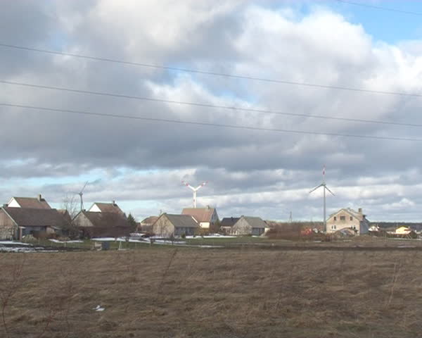 windmills between residential buildings. alternative energy production.