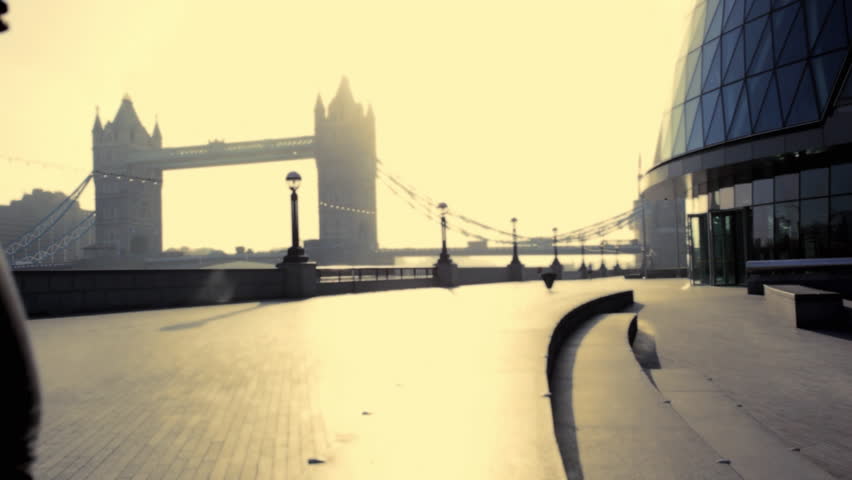 Runner on steps City hall London,Tower bridge in background