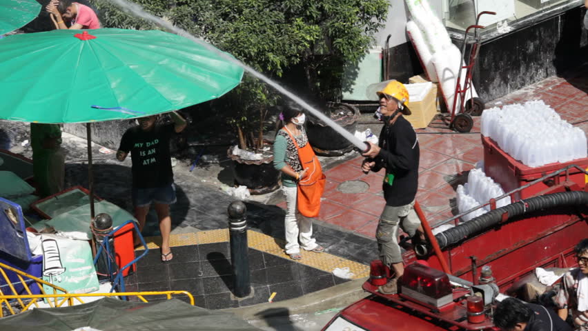 BANGKOK - APRIL 15: A fireman is celebrating Songkran Water Festival at Silom in Bangkok on April 15, 2012. 