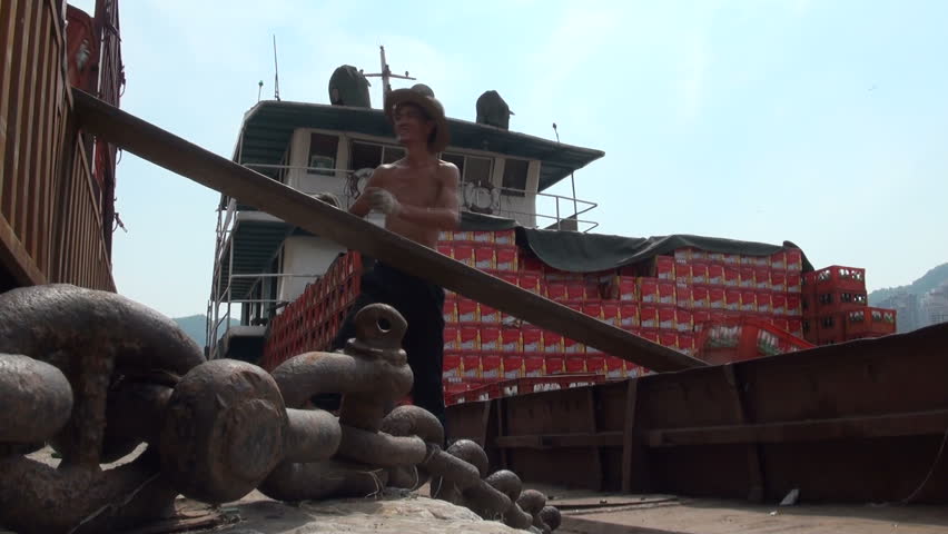 CHONGQING - 17 AUGUST: People are loading beer crates onto a cargo ship August 17, 2011 in Chongqing, China