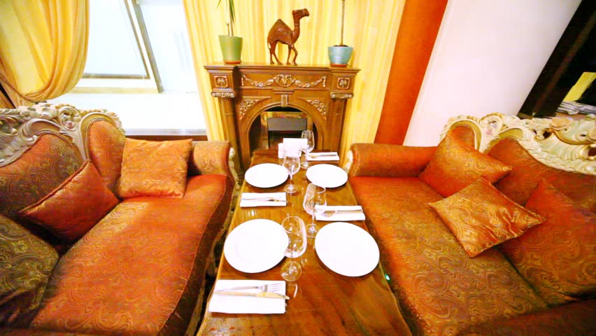 Table stands in a restaurant lounge between sofas and a fireplace