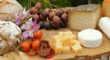 wine glass, blue cheese gouda bread grape food parmesan swiss dairy healthy france milk on table dolly shot outdoors in a vineyard 
