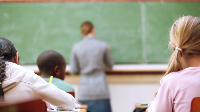Pupils whispering secrets in the classroom
