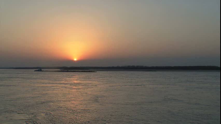 Mississippi river as sun sets into fog