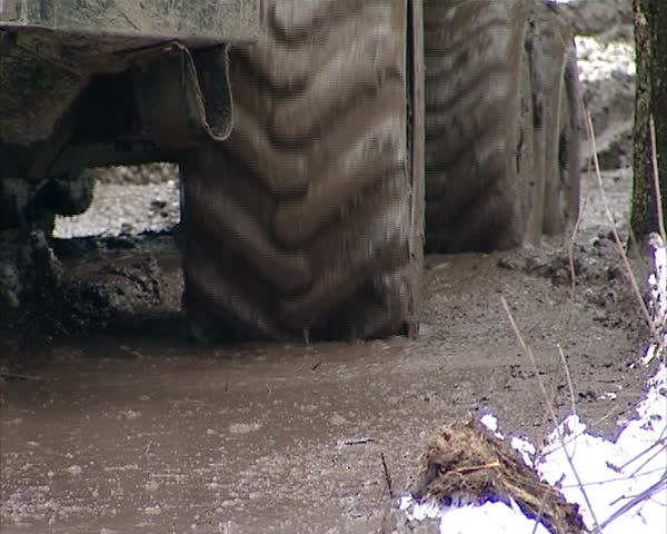 special tree trunk logs transporting tractor go on viscous dirty forest in spring. timber industry