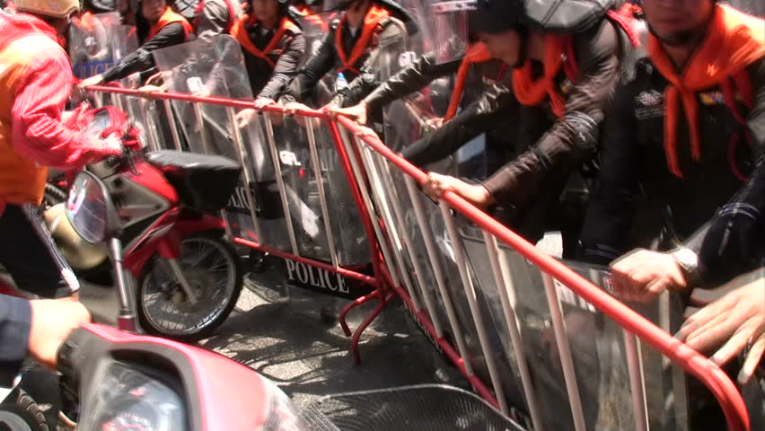 BANGKOK, THAILAND - MARCH 7: Red Shirt protesters face-off government troops in preliminaries to violence at Democracy Monument March , 2010 in Bangkok, Thailand