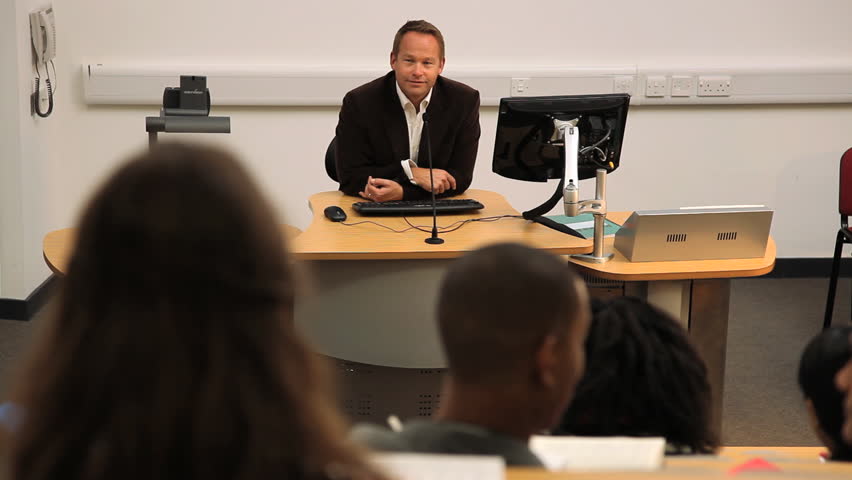 Teacher in front of students in lecture class speaking